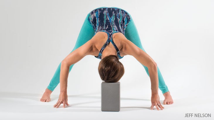 wide legged standing forward bend with a block wide legged standing forward bend with a block