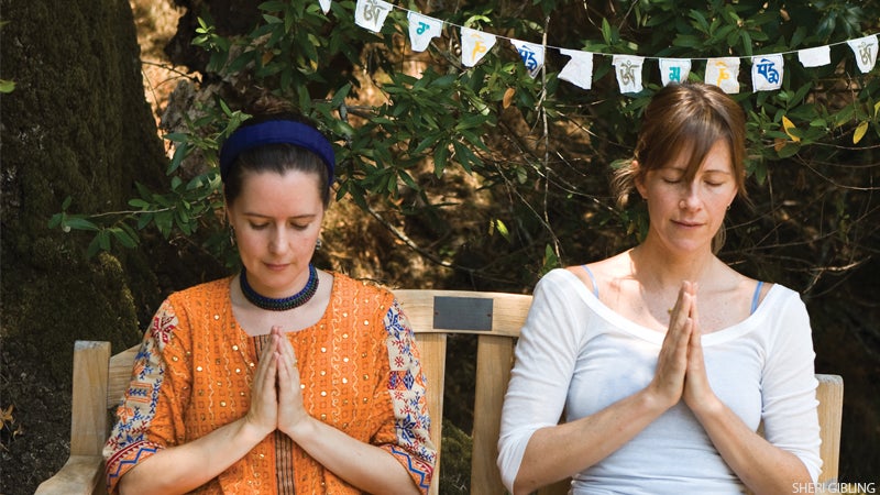 two women meditating outside two women meditating outside