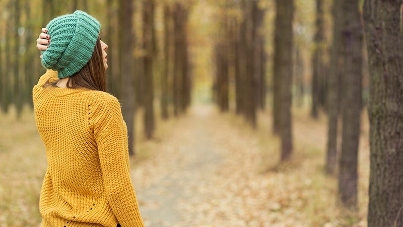 dealing with guilt, woman walking in woods, outdoors, fall dealing with guilt