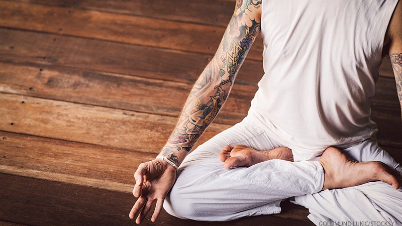 man meditating with tattoos man meditating with tattoos