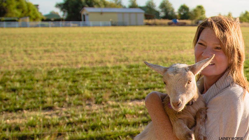Lainey Morse cuddles a goat. Lainey Morse cuddles a goat.