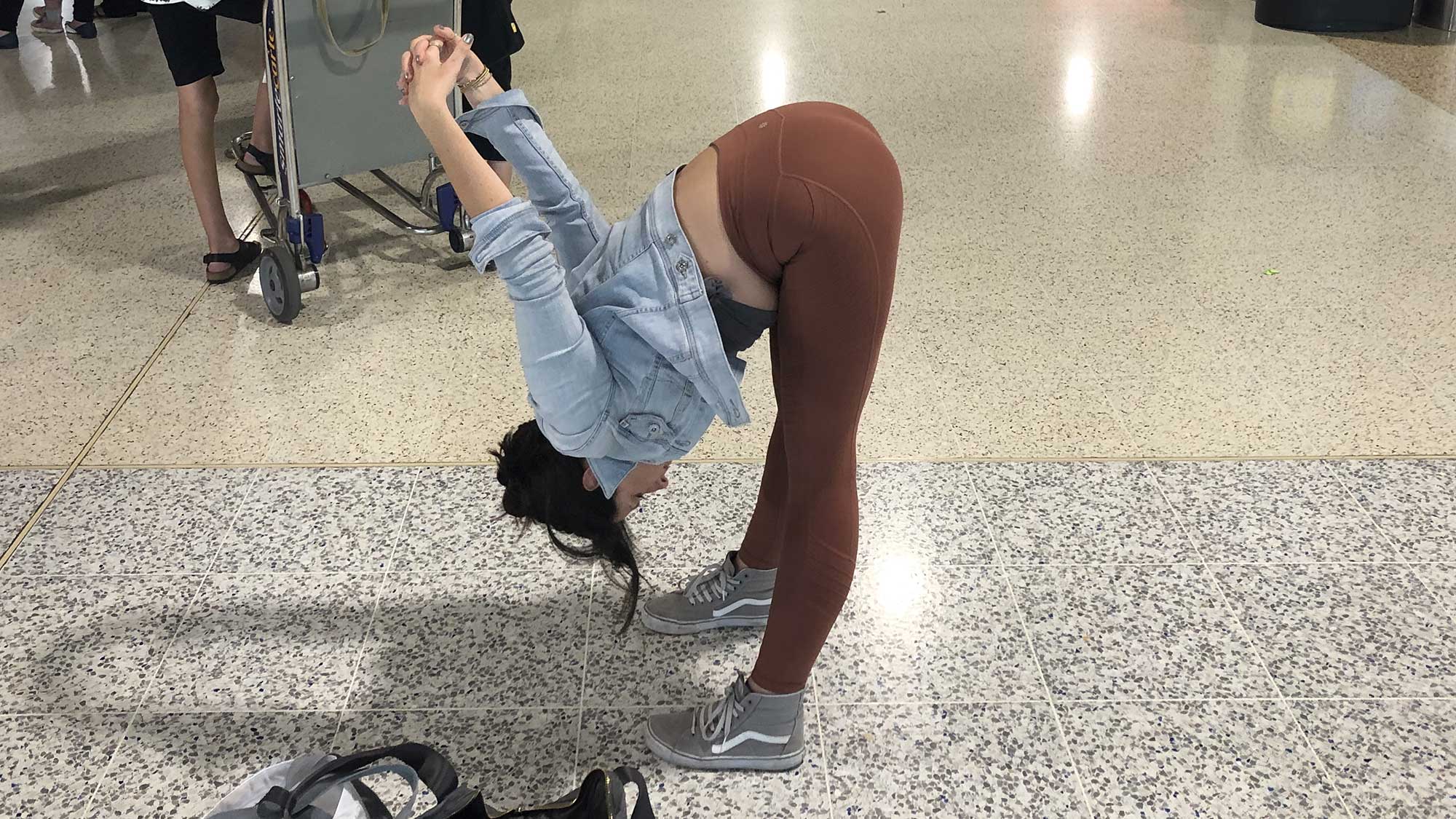 Uttanasana-with-c-clasp Uttanasana (Standing Forward Bend), after flying
