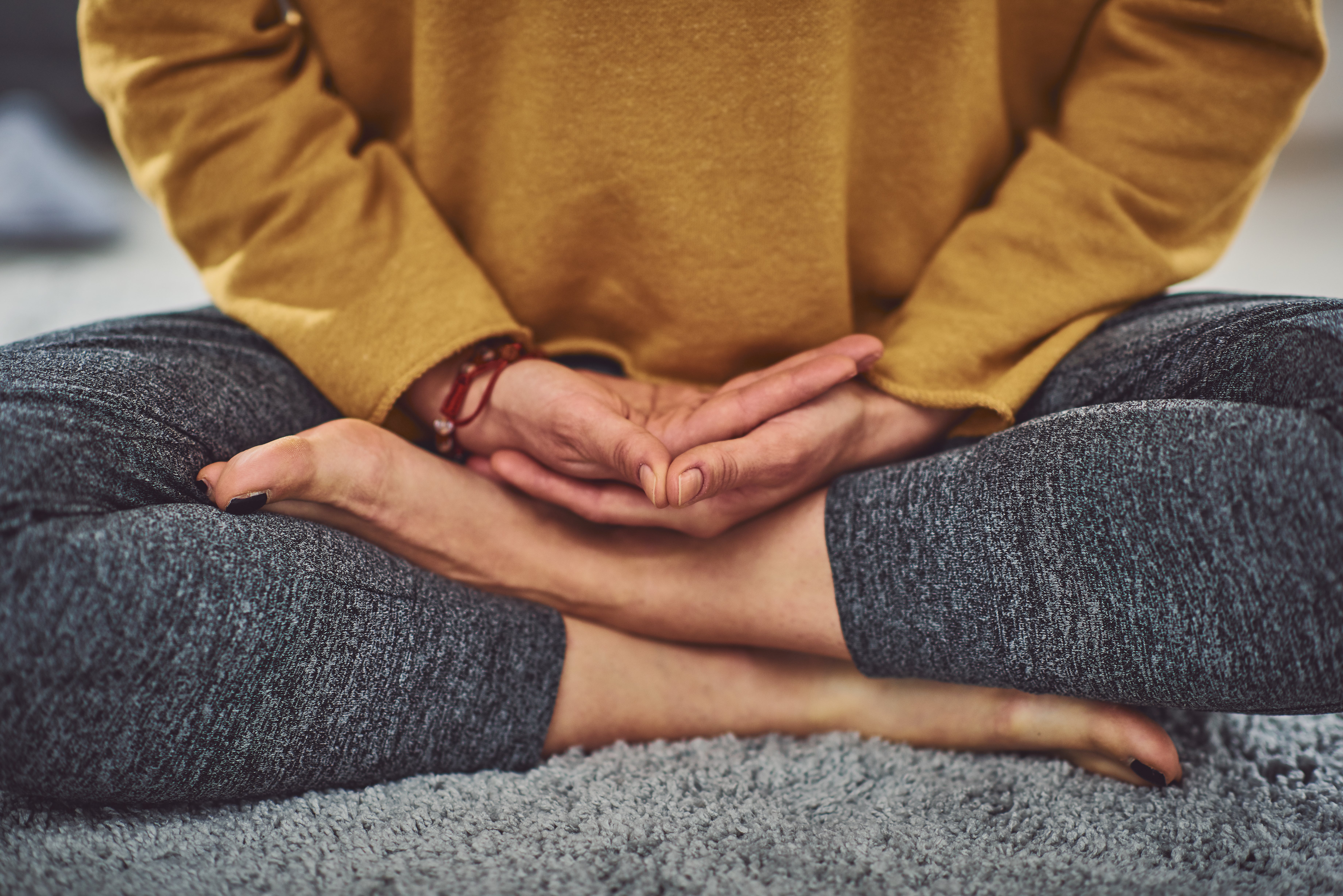 iStock-1173321304 Hands and legs in meditation