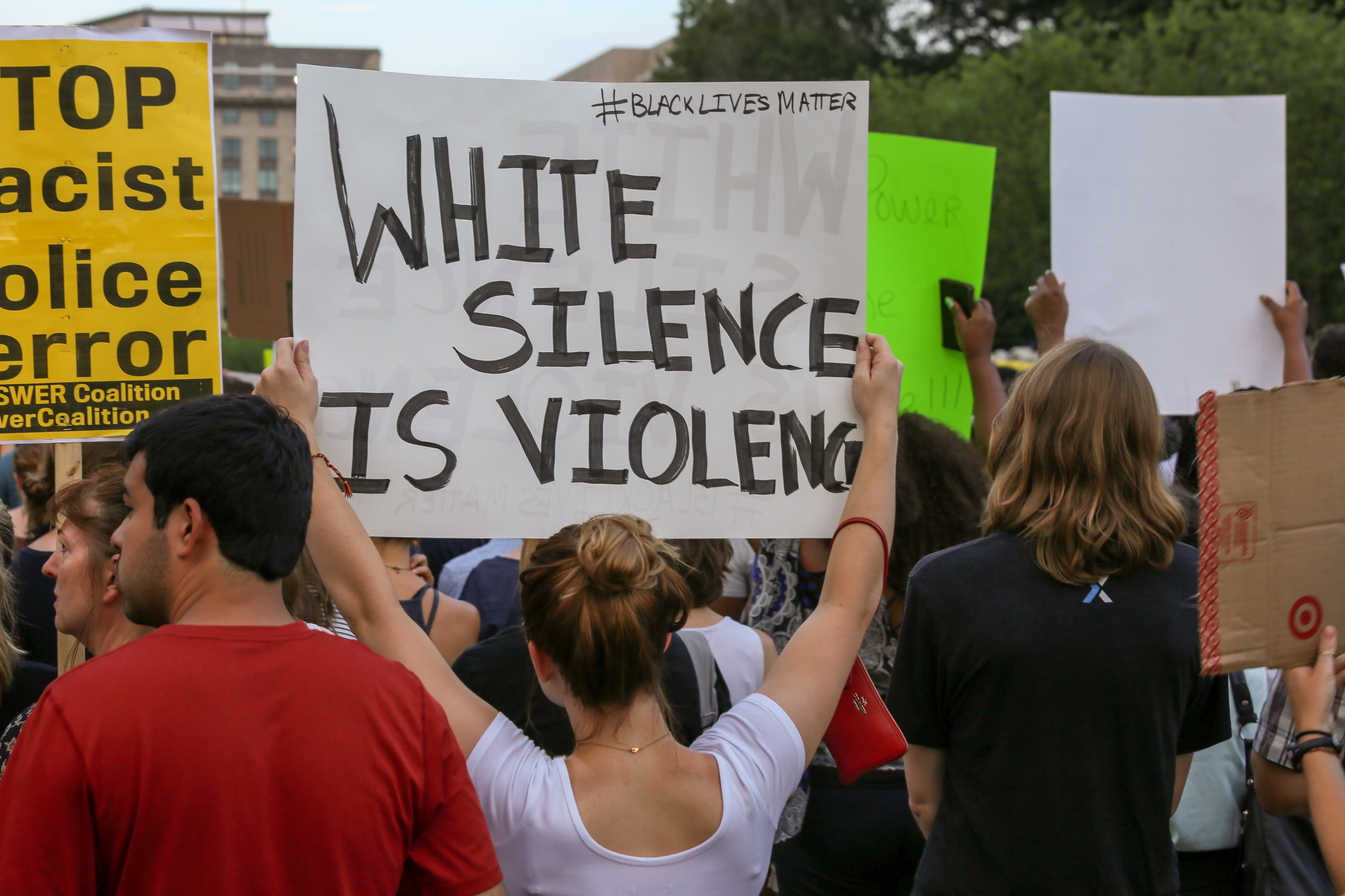 iStock-545278312 white woman holding up black lives matter sign