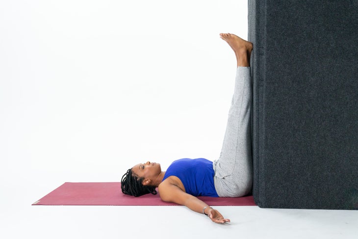 Woman practices Legs-Up-the-Wall Pose