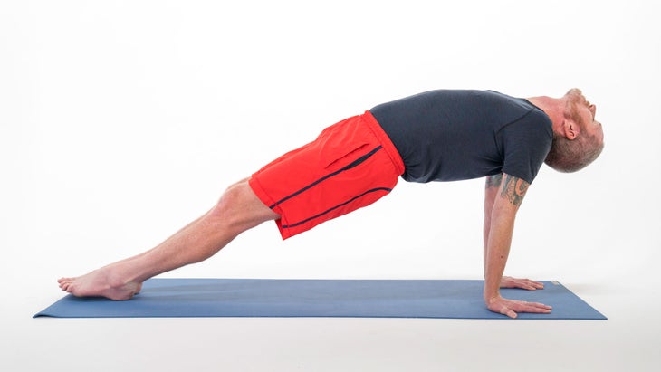 A man demonstrates Reverse Plank or Upward Plank Pose (Purvottanasana) in yoga
