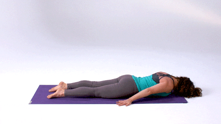 Woman demonstrates Locust Pose