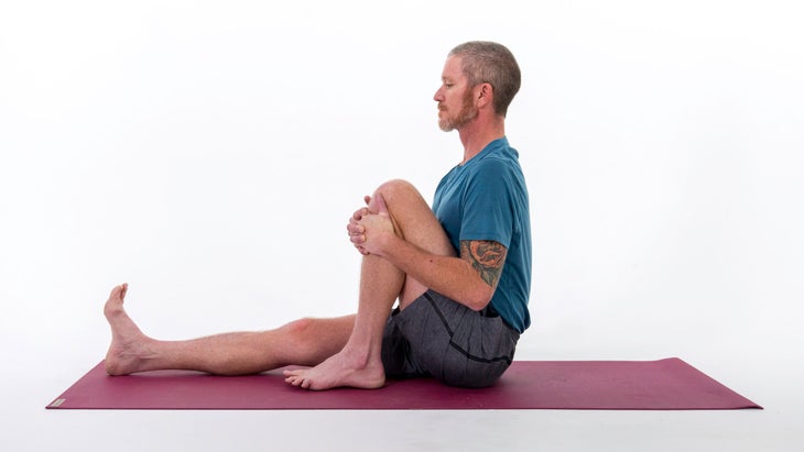 Man doing Pose Dedicated to the Sage Marichi I (Marichyasana I) variation