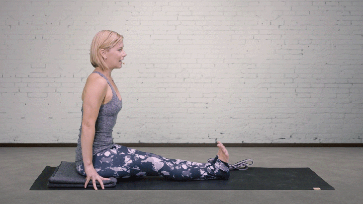 Woman demonstrates Seated Forward Bend