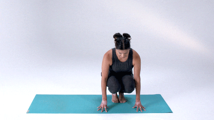 Woman demonstrates Side Crane (Crow) Pose