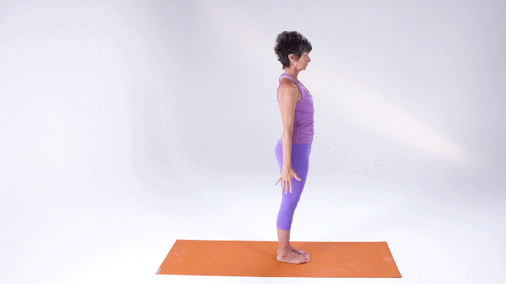 A woman demonstrates Chair Pose (Utkatasana) in yoga