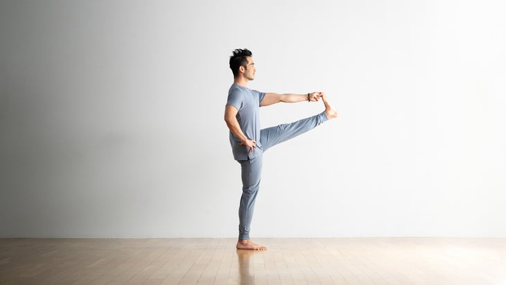 A person demonstrates Extended Hand-to-Big-Toe Pose I in yoga