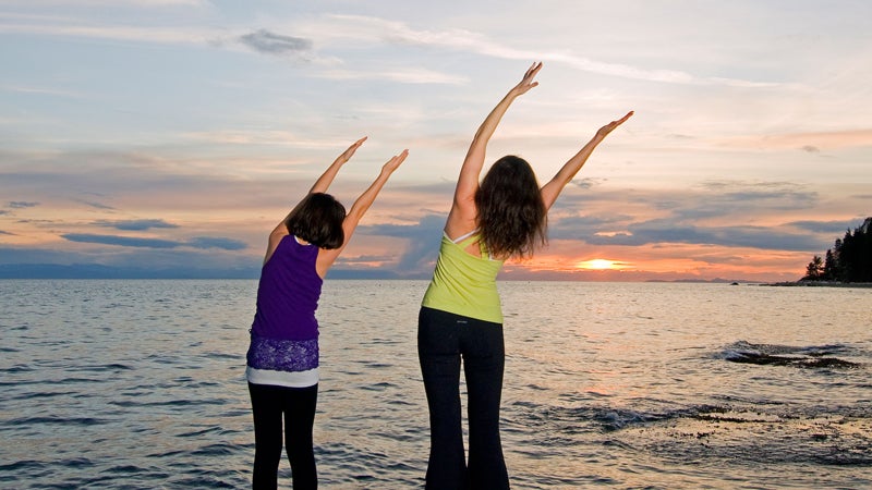 family mother and daughter yoga sunset