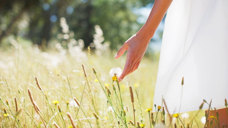 C2W9E5 Woman walking through field. Image shot 2010. Exact date unknown.
