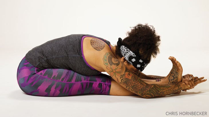 Nov 14 Home Practice Paschimottanasana Seated Forward Bend A woman practices Paschimottanasana (Seated Forward Bend) in yoga