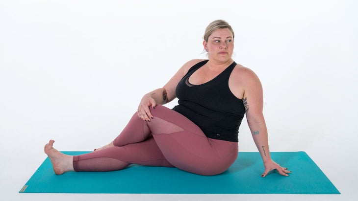 Woman demonstrates a variation of Pose Dedicated to the Sage Marichi III