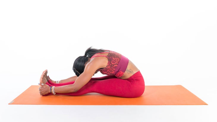 Woman demonstrates Seated Forward Bend