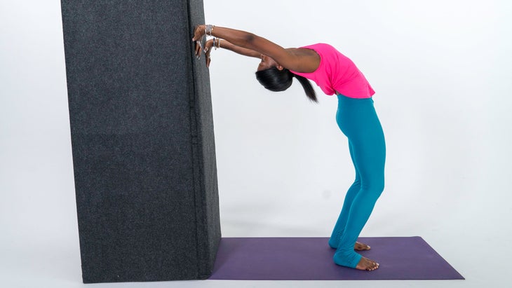 Woman demonstrates a variation of Upward-Facing Bow Pose