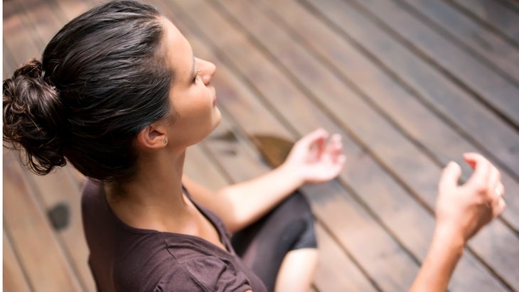 elevated-view-of-woman-meditating-picture-id905082930 None
