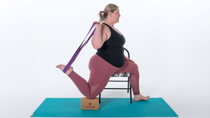 Woman demonstrates a variation of One-Legged King Pigeon II