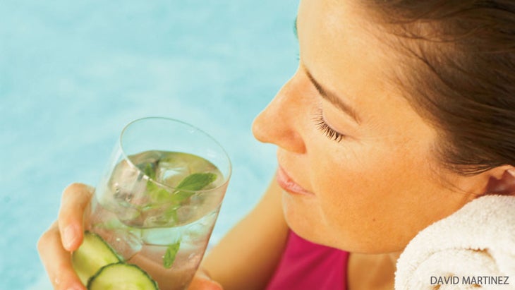 woman by pool sipping water woman drinking water