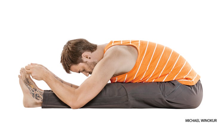 HP_260_15_FNL paschimottanasana A man performs Paschimottanasana (Seated Forward Bend) in yoga