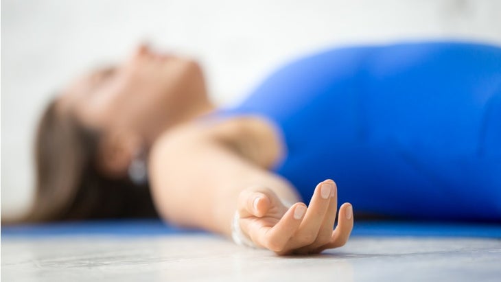 young-attractive-woman-in-corpse-pose-white-studio-background-picture-id639102898 yoga nidra relaxation pose