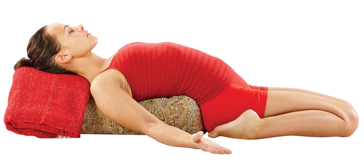 16p-1 A woman demonstrates Supta Virasana in yoga