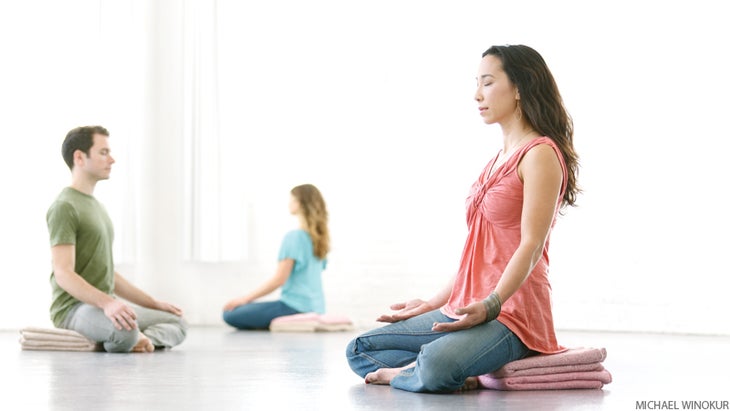 three people meditating three people meditating