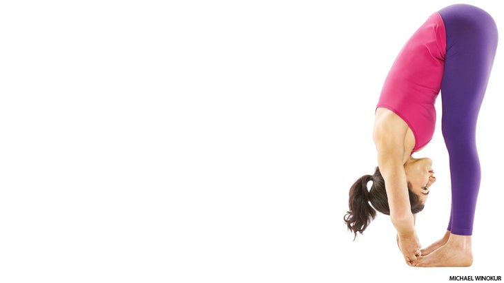 yoga woman in padahastasana forward fold yoga woman in padahastasana forward fold