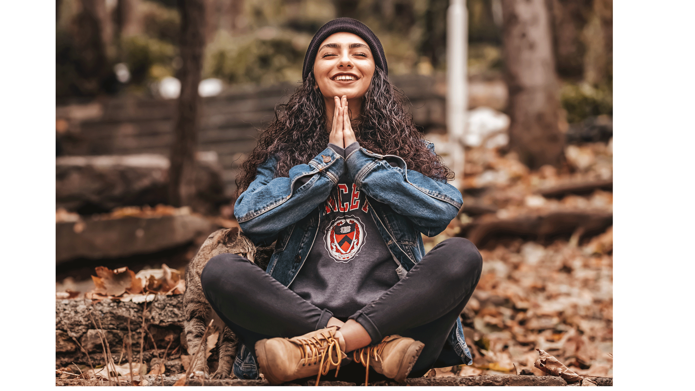 Woman sitting cross-legged on the forest contemplating common misconceptions about meditation