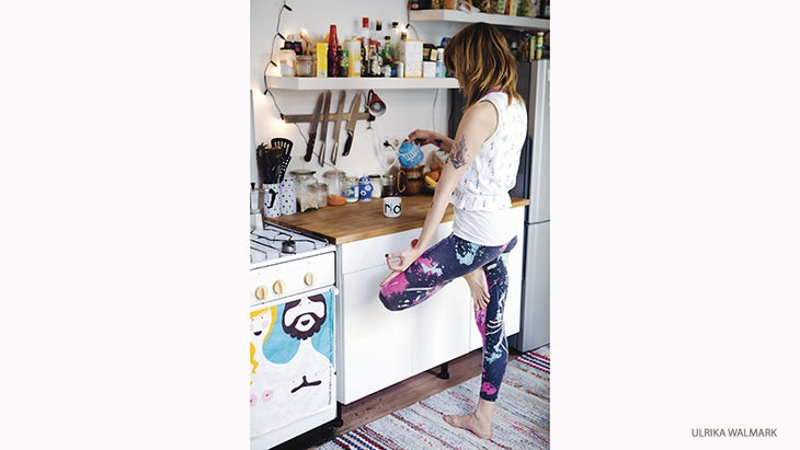 Woman doing Tree Pose in Kitchen Woman Doing Tree Pose in Kitchen