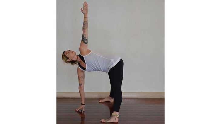 Stefanie Eris in wide legged forward fold twist variation