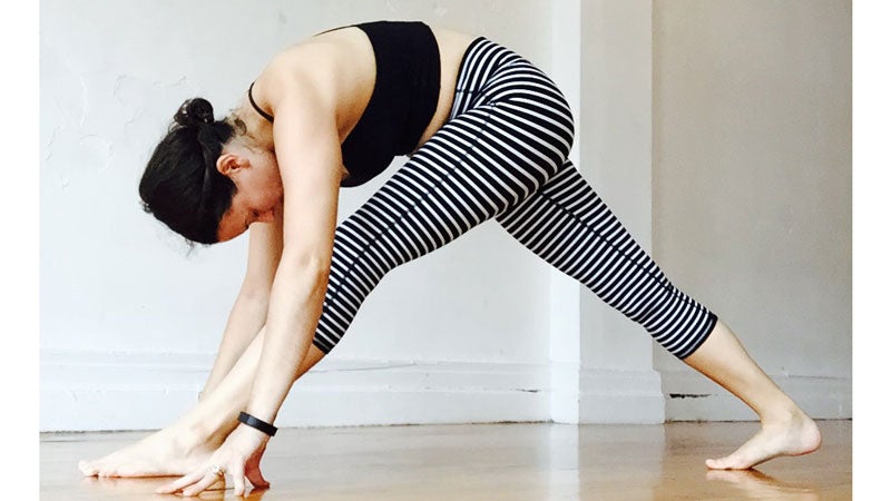 Rae Broderick performs a single leg forward bend.