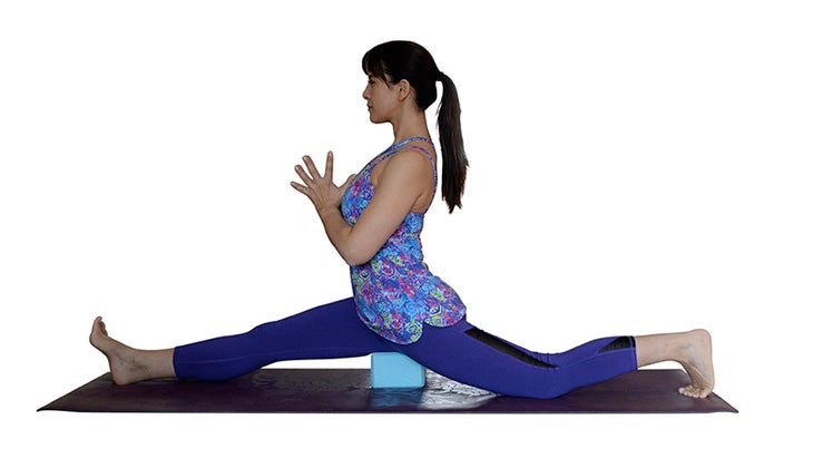 Two Fit Moms perform a Yoga Split with a block. Two Fit Moms perform a Yoga Split with a block.
