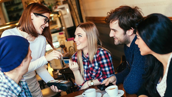 Young-Woman-Paying-A-Bill-By-Credit-Card-000056394026_Medium couple eating, going out to eat, feminism