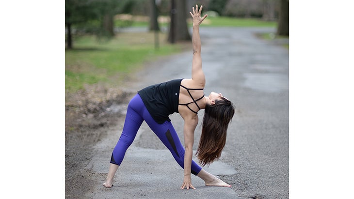 Two Fit Moms perform Triangle Pose. Two Fit Moms perform Triangle Pose.
