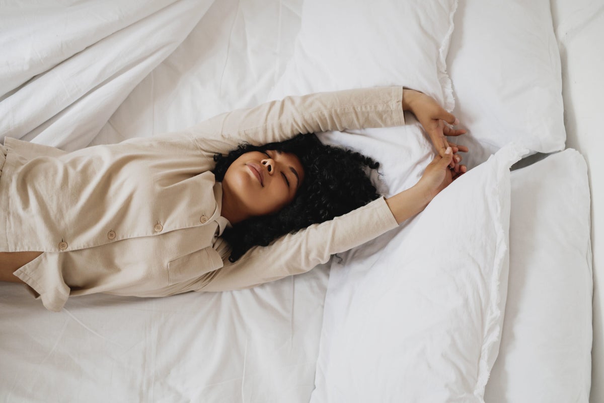 Can’t Sleep? Try These 6 Restorative Poses (In Bed)