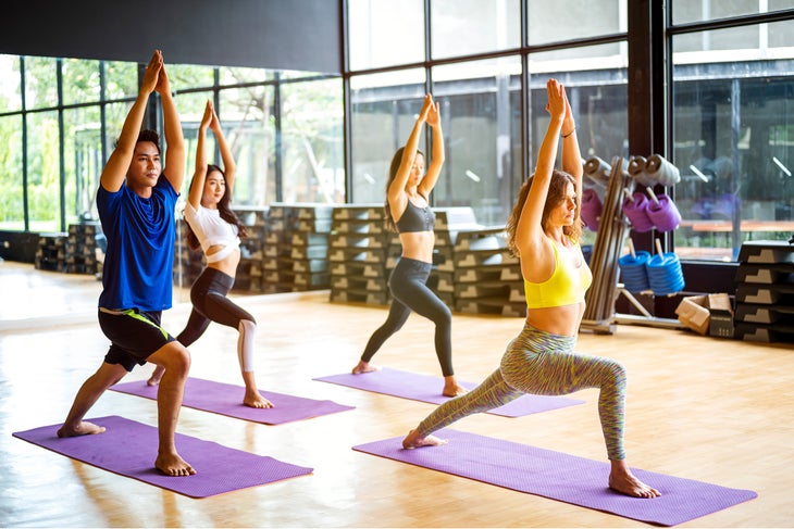 personal trainer teaching yoga