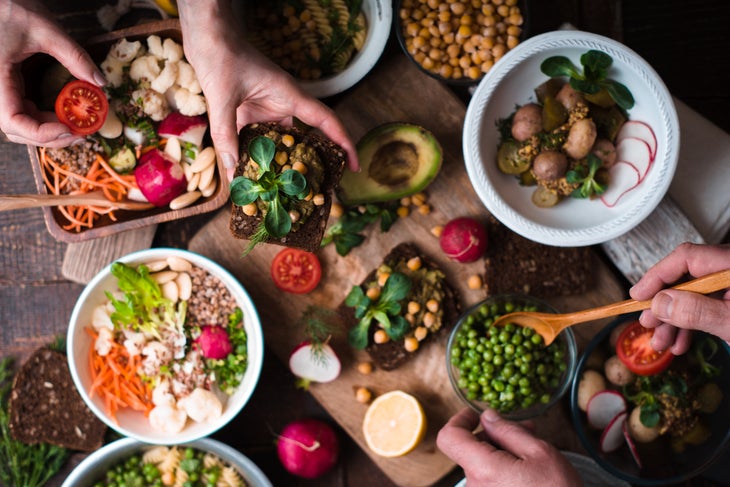 Eating-different-salad-and-appetizer-on-wooden-table-top-view-650607142_1256x838 (1) None