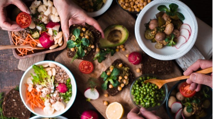 eating-different-salad-and-appetizer-on-wooden-table-top-view-picture-id650607142 (1) None