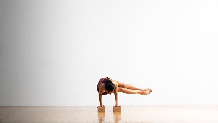 Person practicing Bakasana Side Crane