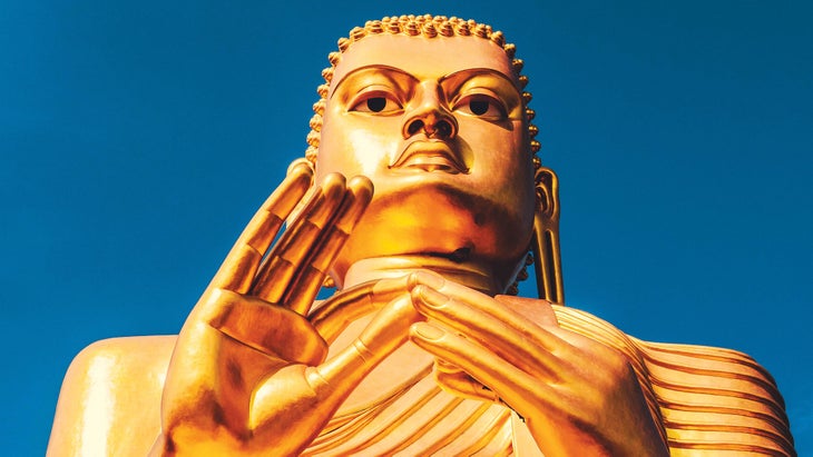 Resized-TravelDest_309_1705524_bjk Giant golden Budda statue against a dark blue clear sky