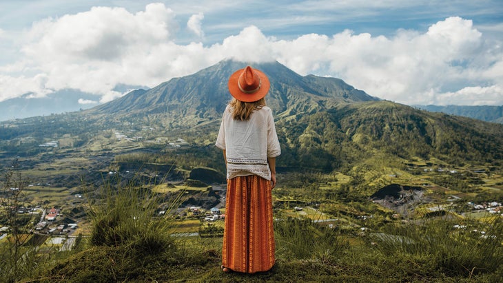 Resized-TravelDest_309_583821_bjk Woman in native dress and hat overlooking a mountain valley