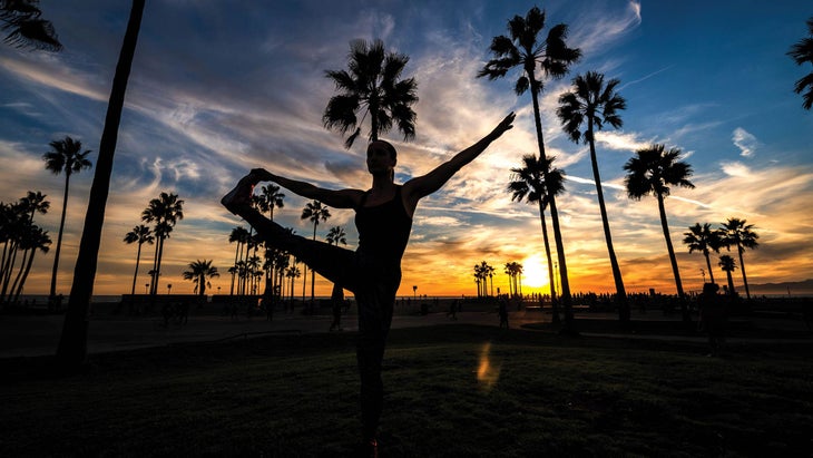 Resized-TravelDest_309_666930234_NEW_bjk Woman doing yoga at sunset in Los Angeles, California