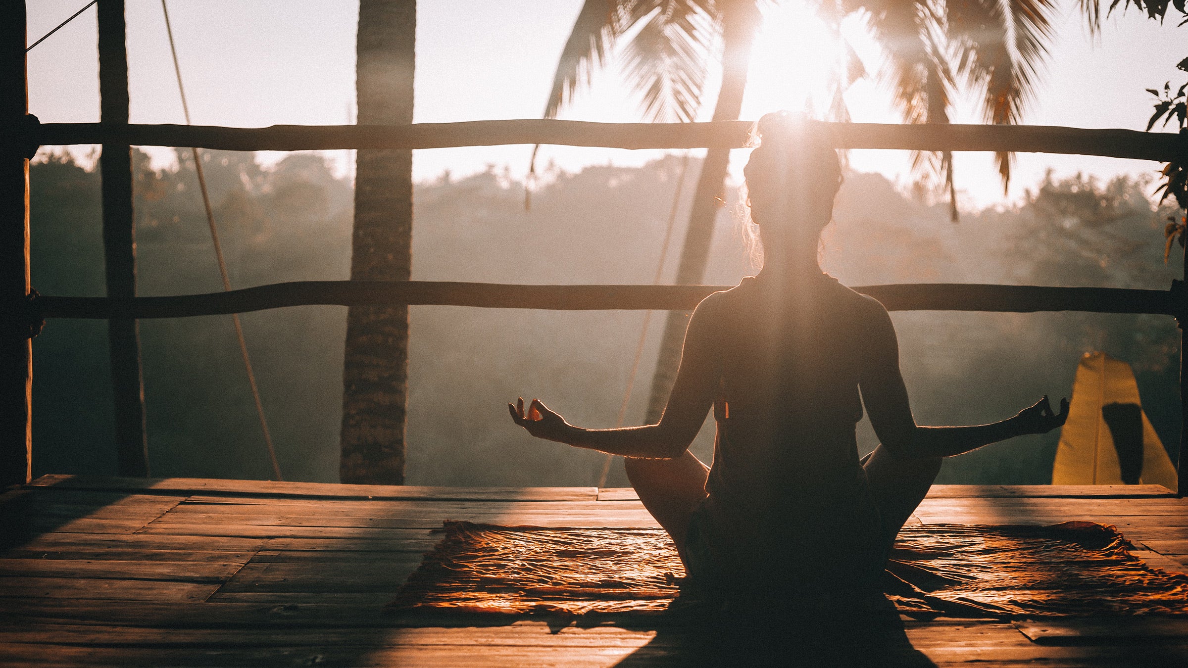 A person meditates on a deck in Ubud, Bali