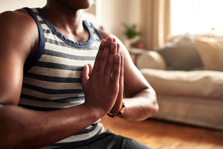 hands-TJS man sits in meditation