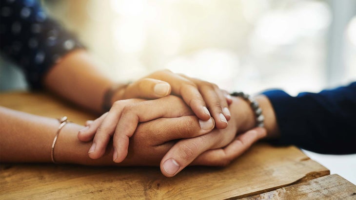 hand-holidng-friends Two friends grasping hands