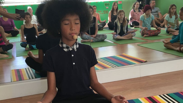 kidyogameditation Tabay Atkins, 11, teaches a yoga class.