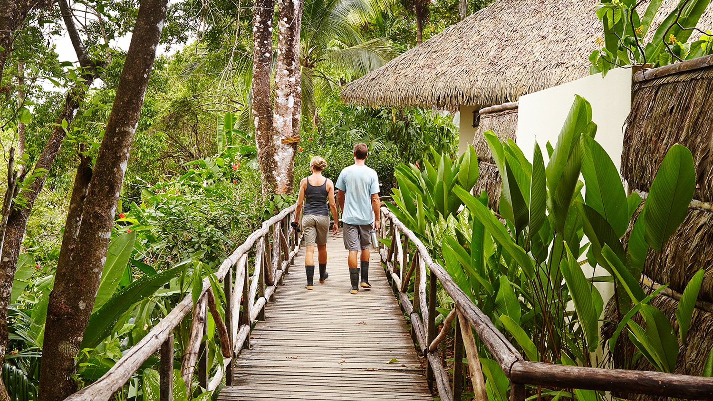 Couple walking on boardwalk in Costa Rica